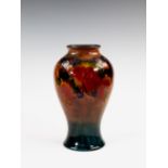 A Moorcroft flambé glazed vase, 1930s, of inverted baluster form, decorated in the Leaves and