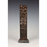 A 19th century carved oak and lead doorstop, using an earlier (17th / 18th century) carved oak