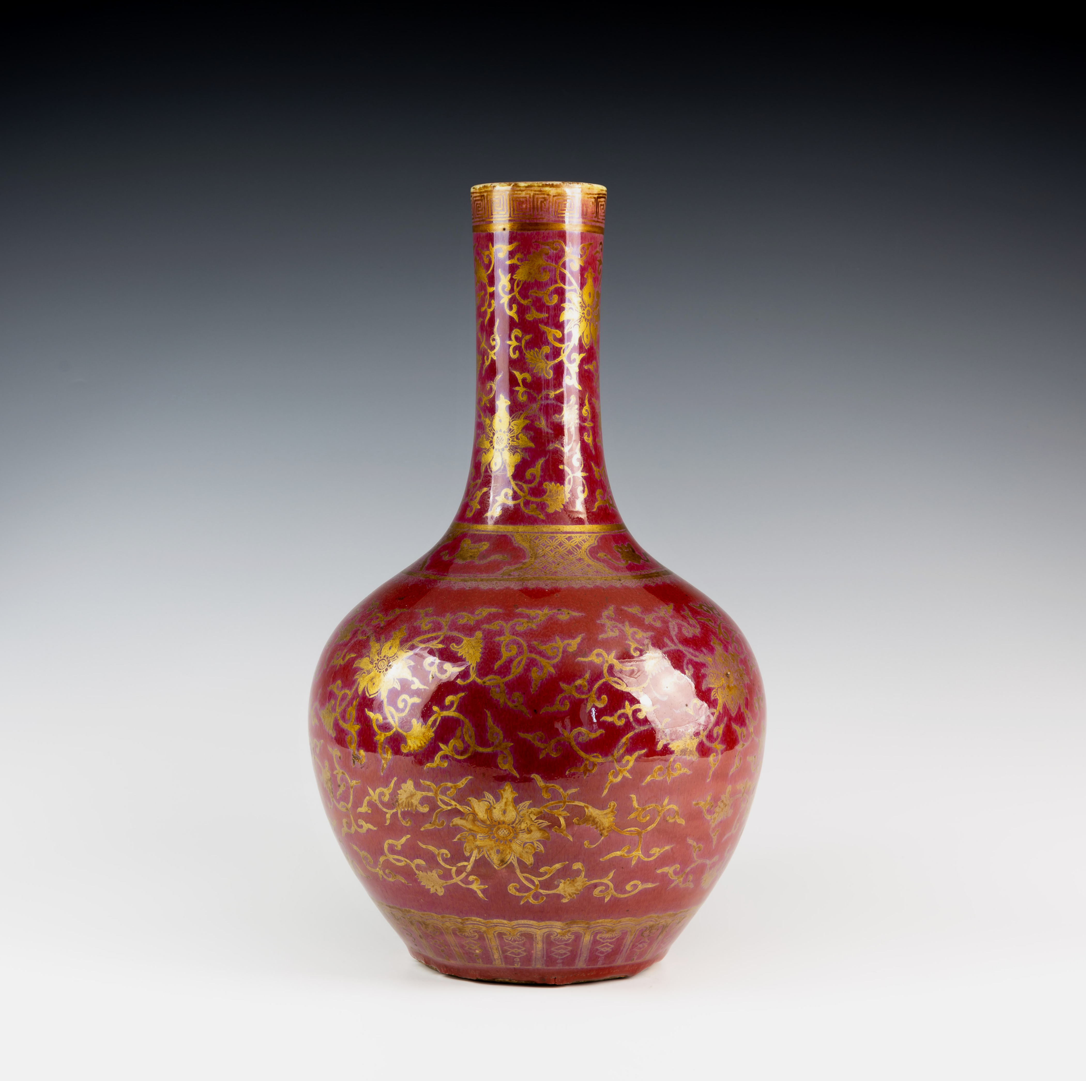 A 19th century Chinese claret red porcelain vase & stand, of bottle form, the body decorated with