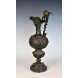 A 19th century neo-classical bronze ewer, decorated with winged cherubs holding classical reserves