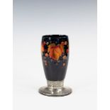 A Tudric Moorcroft Leaves and Fruit pattern vase, 1930s, with graduated dark blue ground, raised