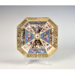 A Dresden style porcelain dish, c.1900, octagonal, painted with panels of courting figures and