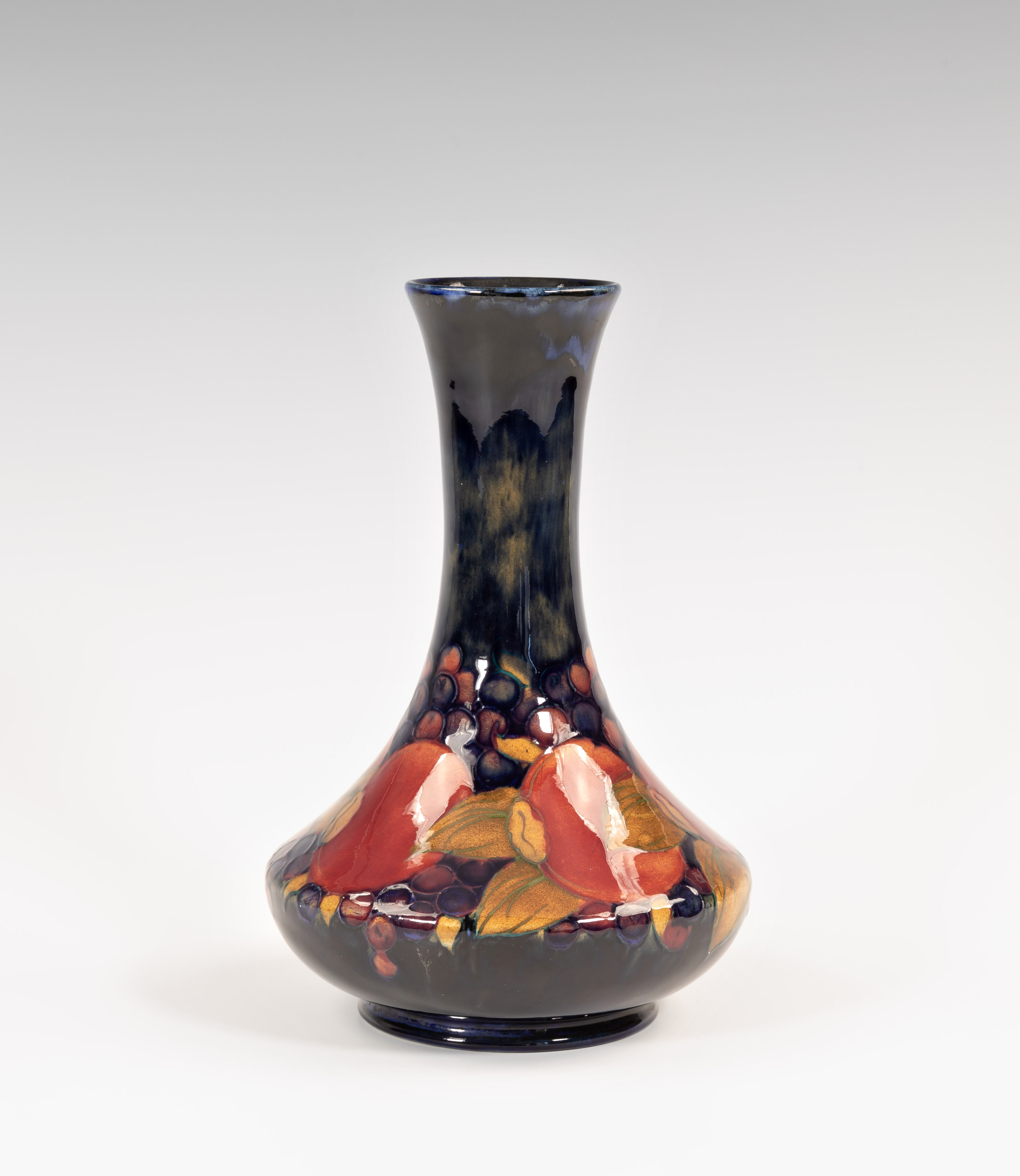 A Moorcroft pomegranate pattern bottle vase, 1920s, of shouldered, bottle form with slightly