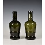 A pair of large black glass mallet bottles, second half 19th century, with double ring girdles and