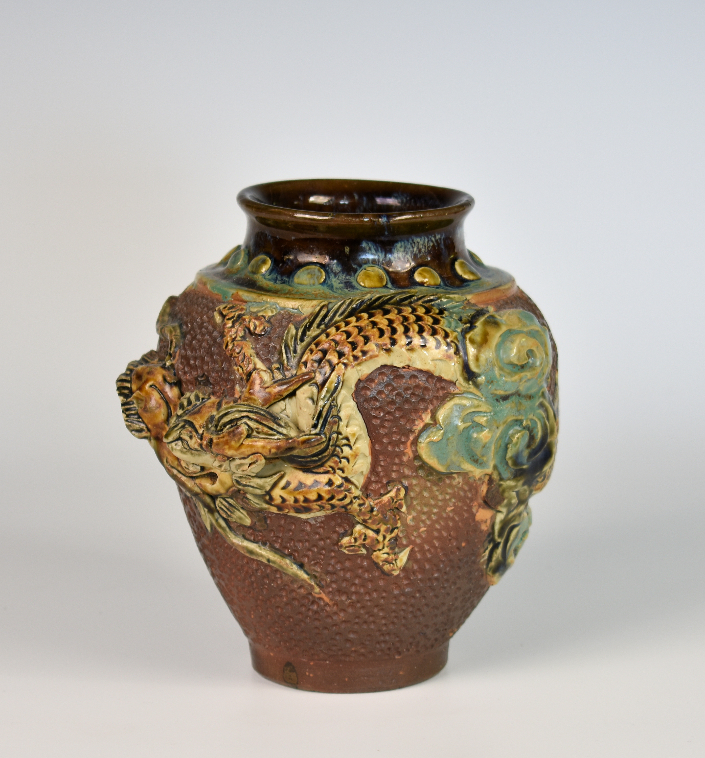 A Chinese stoneware dragon vase, early 20th century, of ovoid form with overall brown glazed dimpled