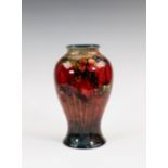 A Moorcroft flambé glazed vase, 1930s, of inverted baluster form, decorated in the Leaves and