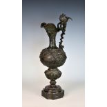 A 19th century neo-classical bronze ewer, decorated with winged cherubs holding classical reserves