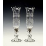 A pair of Baccarat glass storm or hurricane lamps, the tall tulip form shades with etched neo-