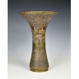 An 18th /19th century Mamluk Revival brass, copper and silver vase, the boldly flared trumpet form