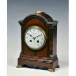 A late 19th century mahogany arched mantel clock, with French twin train movement with platform