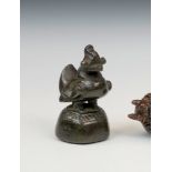 An 18th / 19th century Burmese cast bronze opium weight, in the form of a mythical bird, raised on a