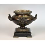 A 19th century patinated bronze twin handled urn, the gadrooned, everted rim over a body of
