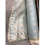 A roll of pale blue, white and silver vintage silk material in original wrapping.