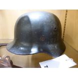 A German M40 steel helmet. Shell only no liner, decal added.