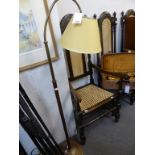 A floor standing brass and wood reading lamp.