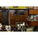 A 19th century mahogany secretaire cabinet on stand,adapted, with some Georgian elements, the flared