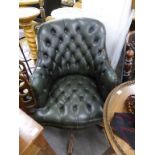 A green leather captains style swivel chair.