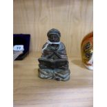 An Austrian cold painted bronze figure of a seated Arab,the figure seated reading a book, stamped to