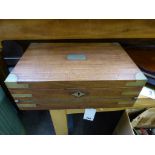 A 19th century teak and brass bound campaign style writing slope,the box opening to reveal green