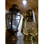 A brass Nauticalia Hurricane oil lamp and a candle holder.