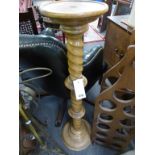 An antique wooden torchere with turned base, rundel and barley twist.,