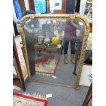 A giltwood over mantel mirror.