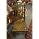 A pair of late Victorian carved oak hall chairs.