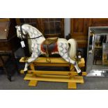 A vintage dapple grey childs rocking horse.