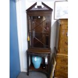 A Chippendale style blind feet carved and glazed mahogany display cabinet on stand,c.1910, the