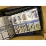 Collection in seven cigarette card albums, with many sets, part sets etc.