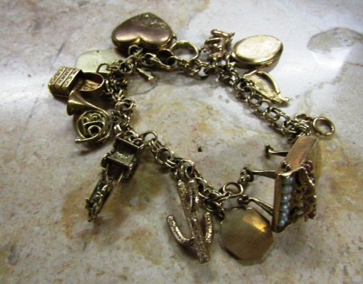 9 Carat Gold Charm Bracelet of Good Weight Decorated with Various Charms