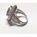 Mauboussin of Paris Ring Set with an Equilateral Modern Cut Aquamarine Further Mounted with Diamonds