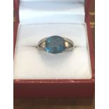Blue Topaz Diamond Decorated Ladies Ring with Oval Cut Centre Stone Mounted on 9 Carat Gold