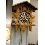 Cuckoo Clock with Roman Numeral Decorated Dial and Oak Leaf Motif Carving and Original Weights