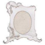 AN EDWARDIAN SILVER-MOUNTED PHOTOGRAPH FRAME, JORDAN & RAYBOULD, LONDON, 1903 of shaped asymmetric