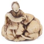 ˜IVORY NETSUKE OF KIMI NO EGUCHI ON A RECUMBENT ELEPHANT, CIRCA 1850 signed: Toun 3.2cm high