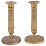 A PAIR FRENCH ORMOLU CANDLESTICKS, SECOND QUARTER 19TH CENTURY cast and milled with a variety of