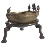 A RITUAL SKULL BOWL, NEPAL, CIRCA 18TH CENTURY mounted in brass, a bodhisattva head and three