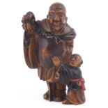 PARTLY LACQUERED WOOD NETSUKE OF A MAN AND BOY, CIRCA 1870 the man holding a cat on his upraised