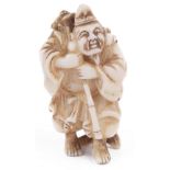 ˜IVORY NETSUKE OF THE LUCKY GOD EBISU, CIRCA 1870 carrying a huge fish over his shoulder, signed: