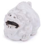 PORCELAIN NETSUKE OF A CROUCHING SHISHI LION, CIRCA 1870 with a loose ball in its mouth, unsigned