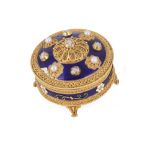 A JEWELLED GOLD AND ENAMELLED BOX AND COVER, 1920s circular, the cover diamond and pearl set, blue