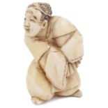 ˜IVORY NETSUKE OF AN ACTOR WITH A FAN, CIRCA 1870 unsigned 4.3cm high Provenance: The Netsuke