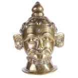 A LARGE BRASS SIVA LINGAM COVER, WESTERN DECCAN, 18TH/19TH CENTURY in the form of a mask, with