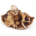 ˜STAINED IVORY NETSUKE OF A NIO ON A GIANT SANDAL, CIRCA 1870 unsigned 4.5cm long Provenance: The