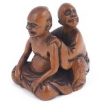 WOOD NETSUKE OF A BLIND MASSEUR AT WORK, CIRCA 1850 unsigned 3.6cm high Provenance: The Netsuke