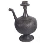 A BRONZE EWER, DECCAN, INDIA, CIRCA 18TH CENTURY the bulbous spiral fluted body on flared ring foot,