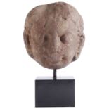 A KUSHAN MOTTLED PINK SANDSTONE HEAD, PROBABLY OF A JINA, MATHURA, 2ND/3RD CENTURY with protruding
