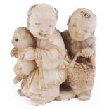 ˜IVORY NETSUKE OF TWO BOYS WITH A PUPPY, CIRCA 1870 unsigned 3.8 cm high Provenance: The Netsuke