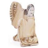 ˜IVORY NETSUKE OF A WOMAN WITH A CAT, CIRCA 1850 she holds a large open fan in her voluminous